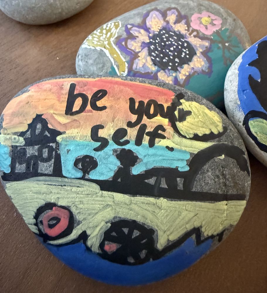 Painted rocks with encouraging messages — art used in therapy sessions